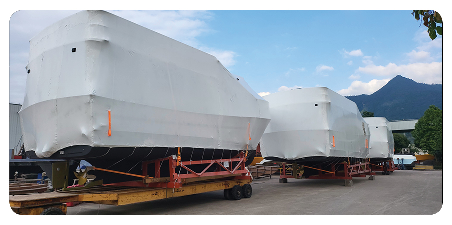 Helmsman Trawlers wrapped in protective plastic for shipping.